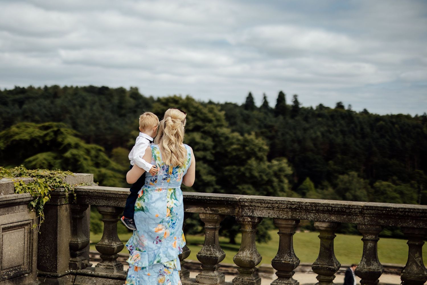 A scenic outdoor wedding venue with stone architecture and lush green surroundings.