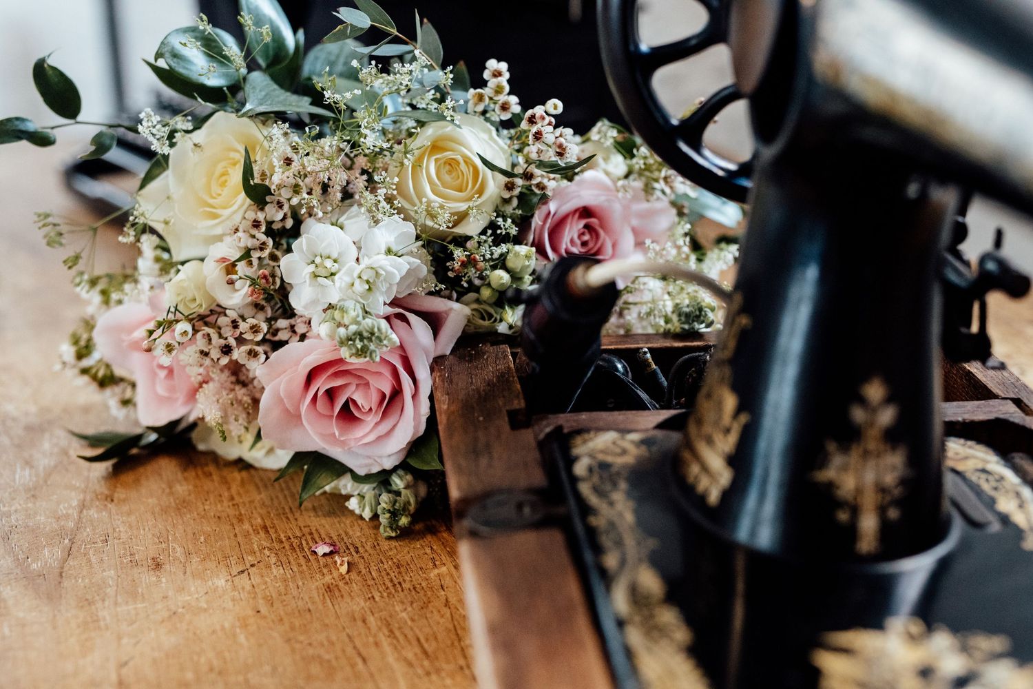 Wedding floral arrangement featuring pink roses and delicate greenery.