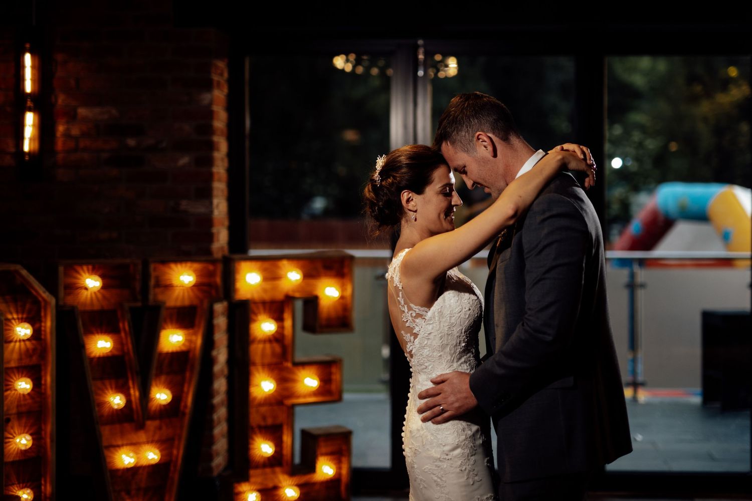 Evening wedding reception scene with warm glowing candle lights.