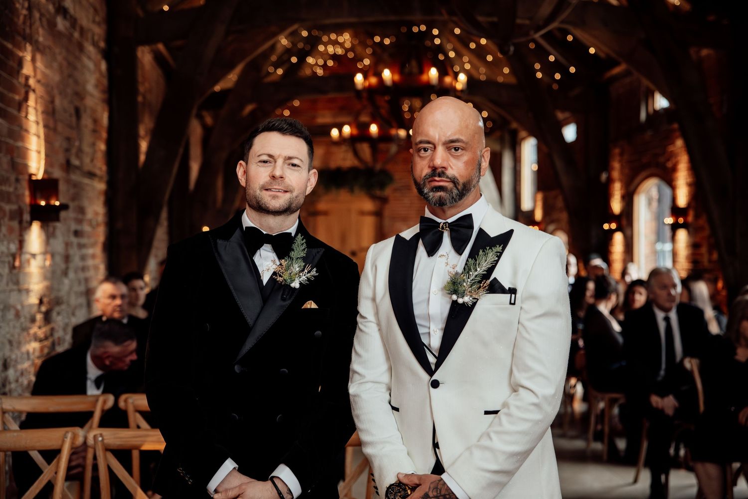 Elegant wedding reception in a rustic brick venue with twinkling lights and formal decor.