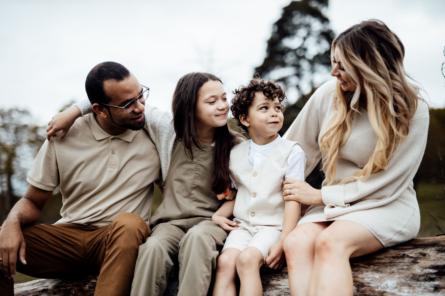 Intimate family moments captured during casual outdoor photoshoot on rocks.