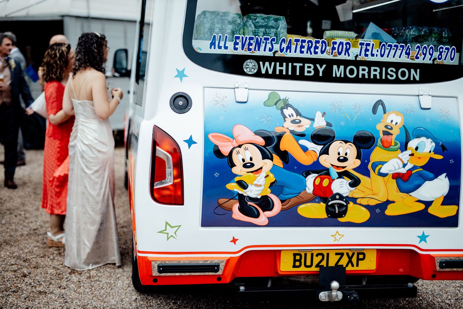 Disney-themed wedding transportation vehicle decorated with cartoon characters.