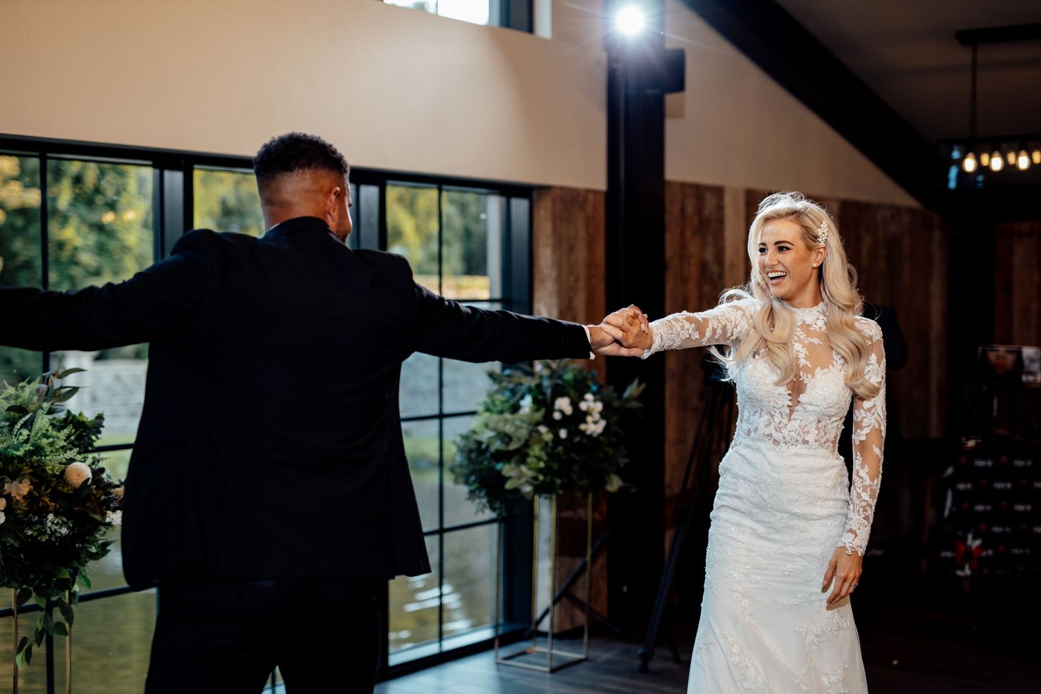 Wedding celebration inside an elegant venue with natural lighting and modern decor.