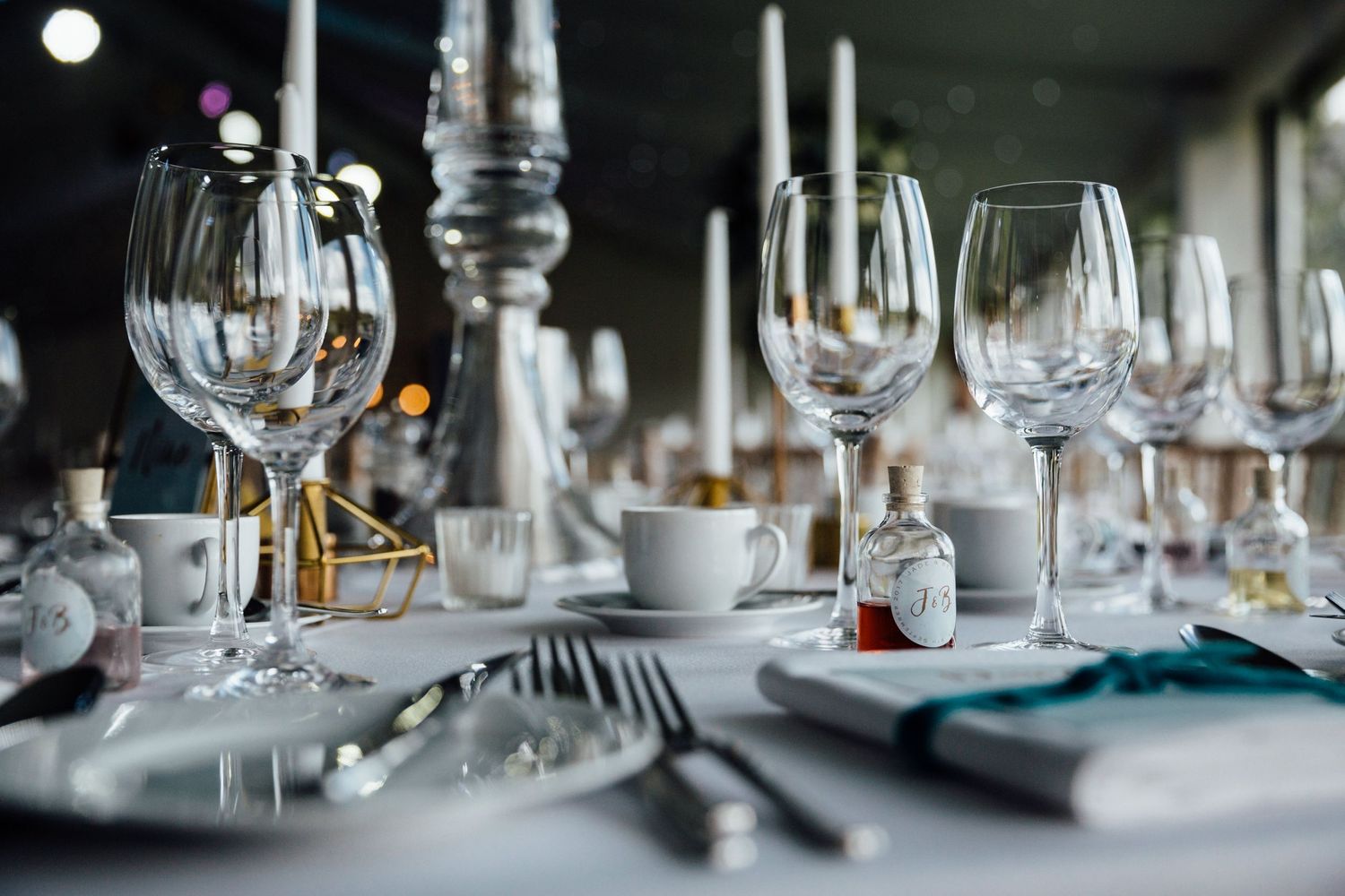 Elegant table setting with wine glasses, silverware and place settings for a formal dinner.
