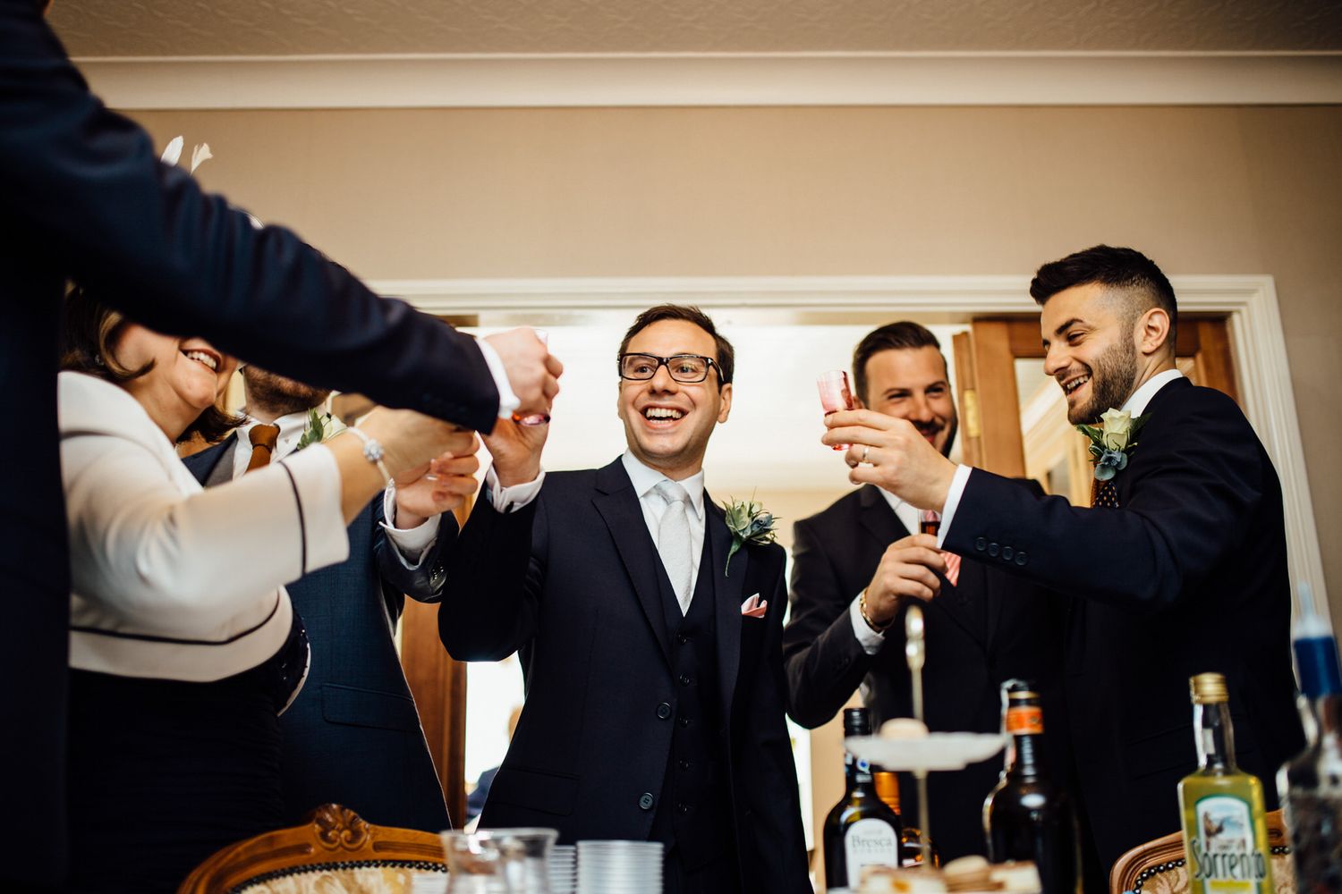 Wedding celebration toast with champagne glasses and formal attire.