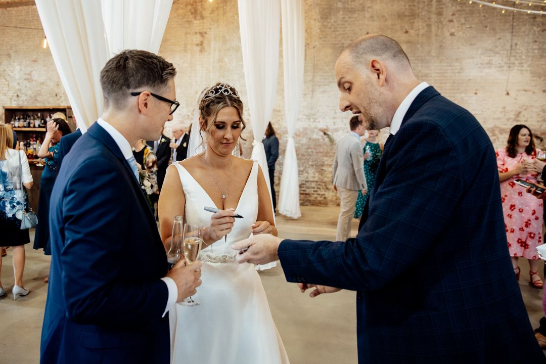 Wedding celebration moments in rustic venue with exposed brick walls and natural lighting.