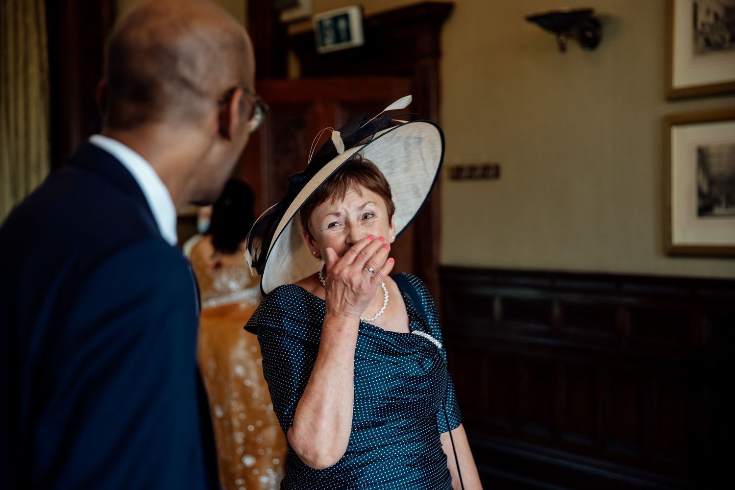 Candid moment of guest's surprised reaction during wedding reception.