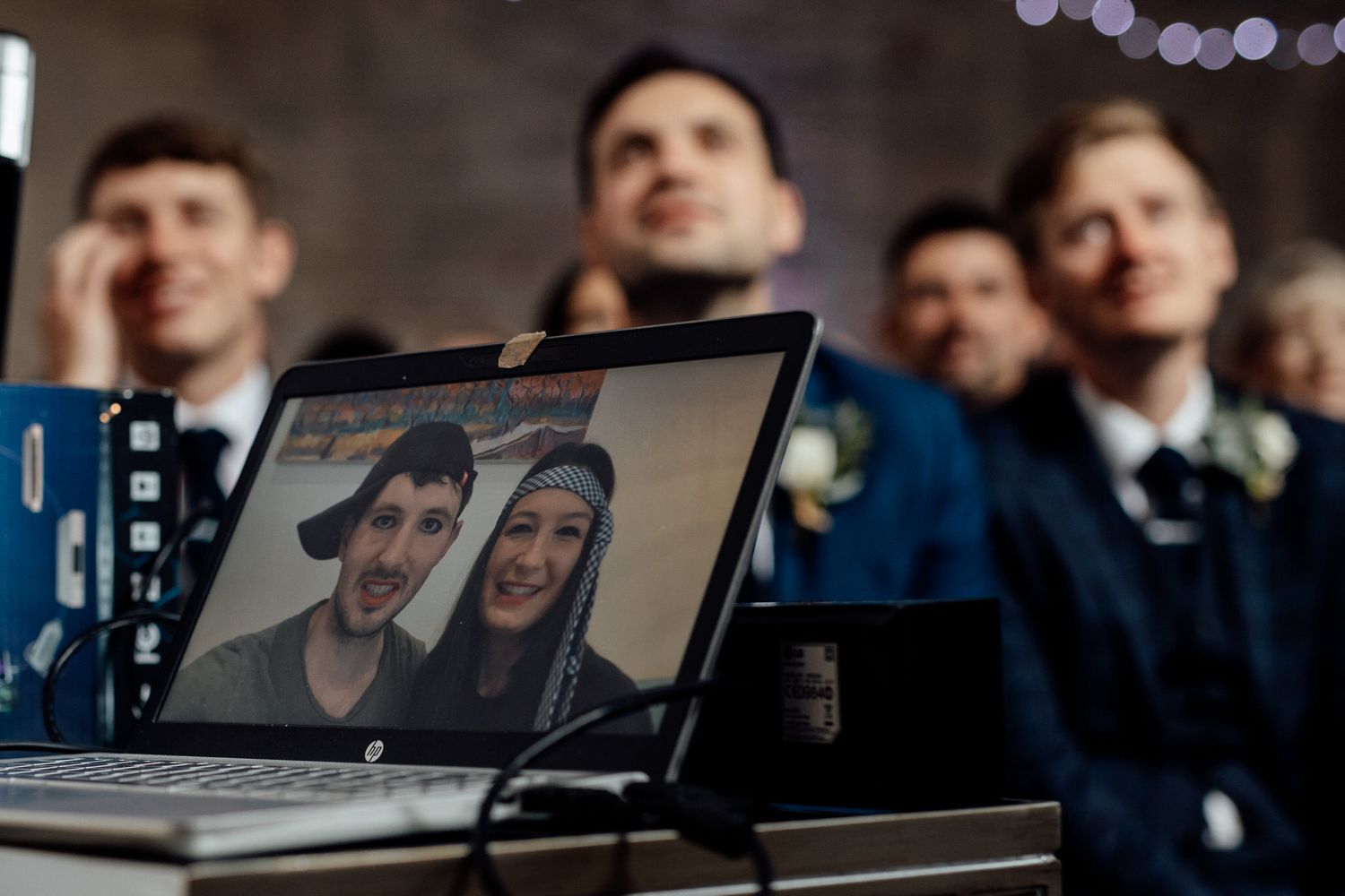 Guests watching attentively during an indoor wedding ceremony.
