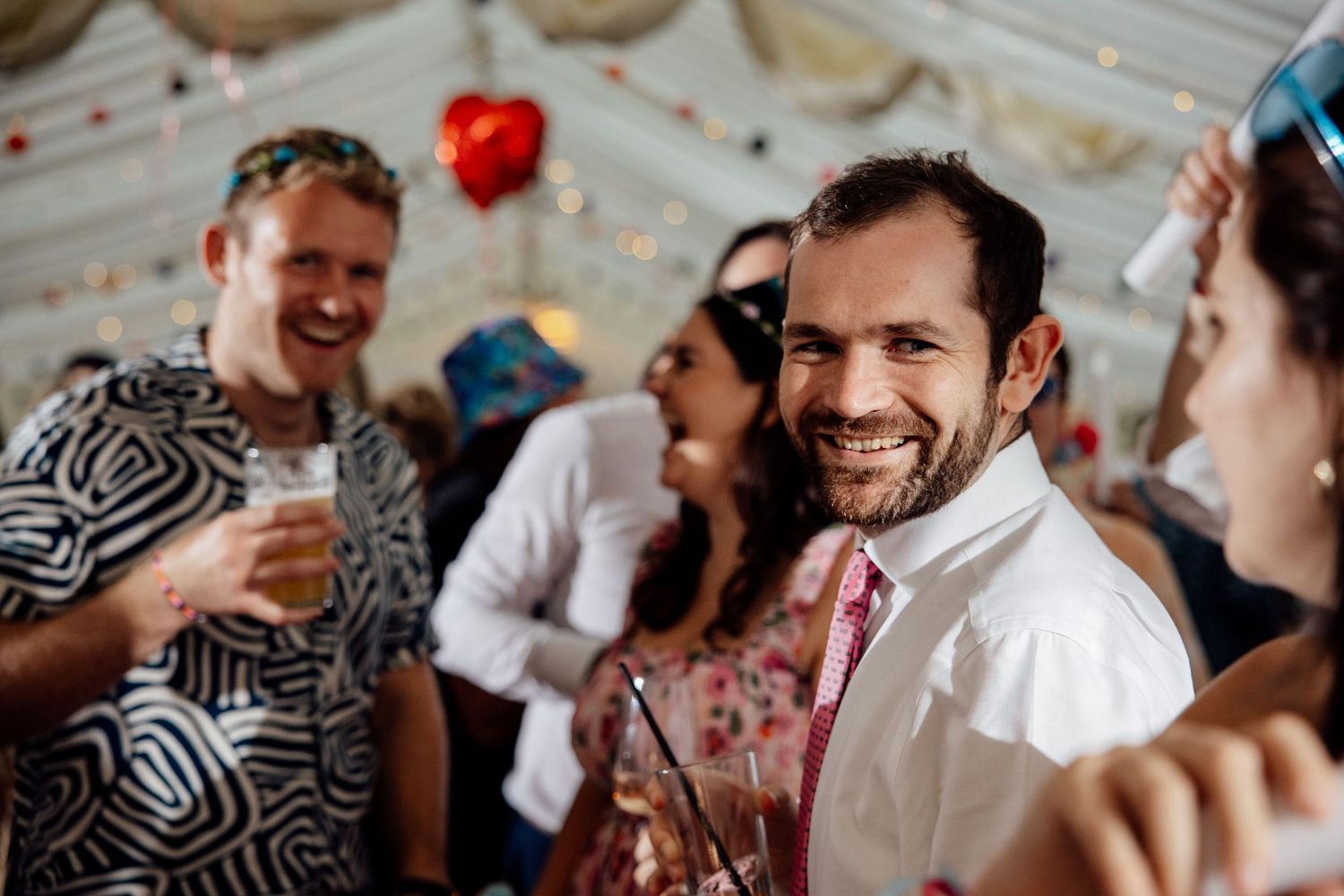 Wedding reception guests sharing laughs during celebration.