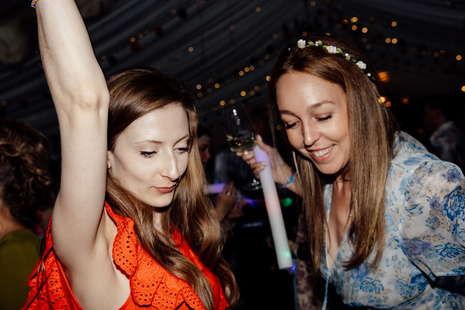 Wedding party dancing and celebrating at a nighttime reception.