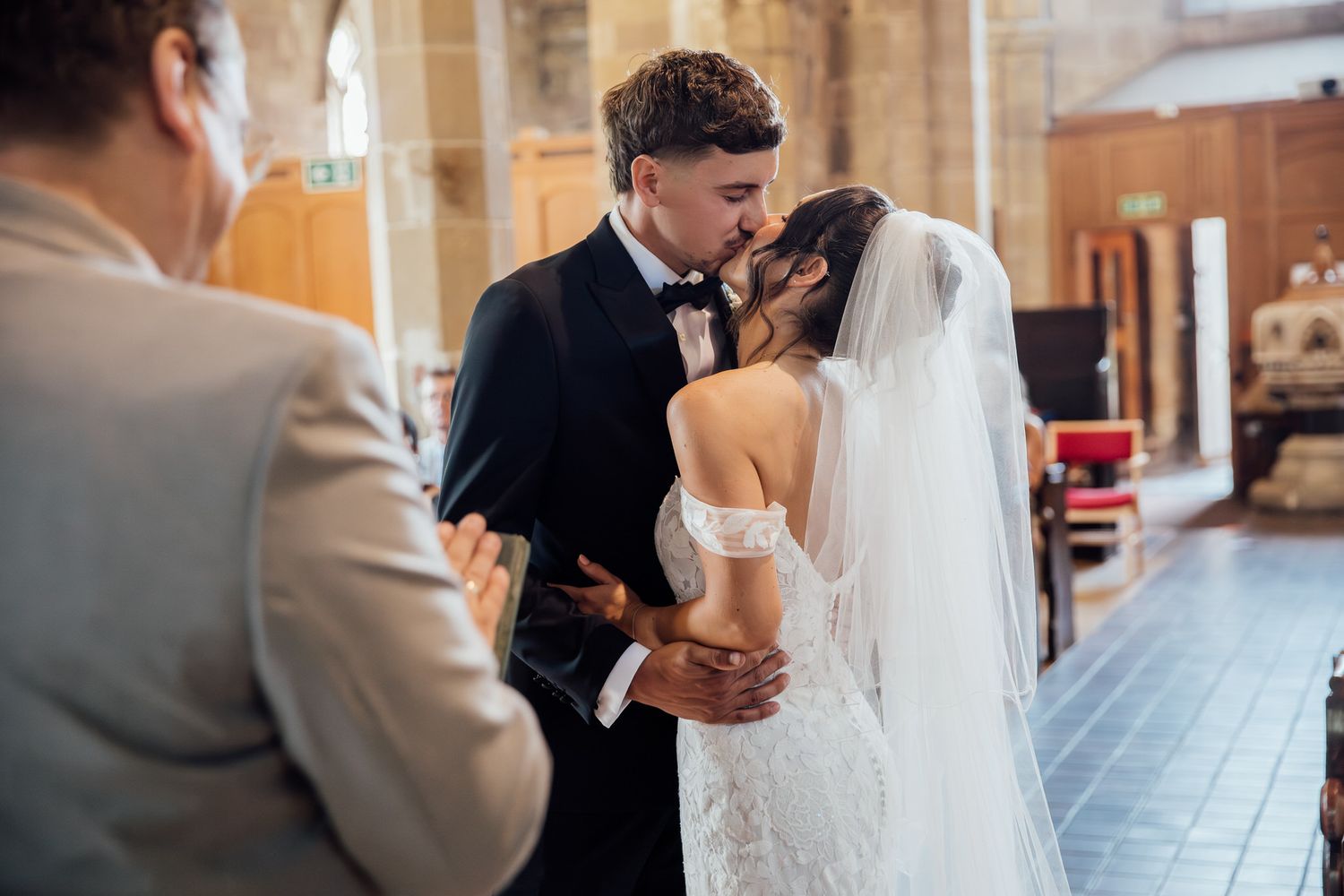 Intimate wedding ceremony moment in a historic church interior.
