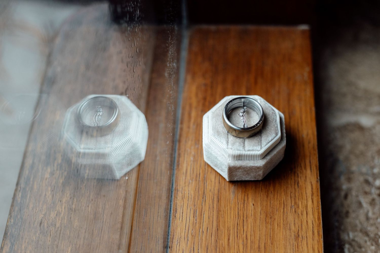Two octagonal glass salt and pepper shakers on wooden surface.