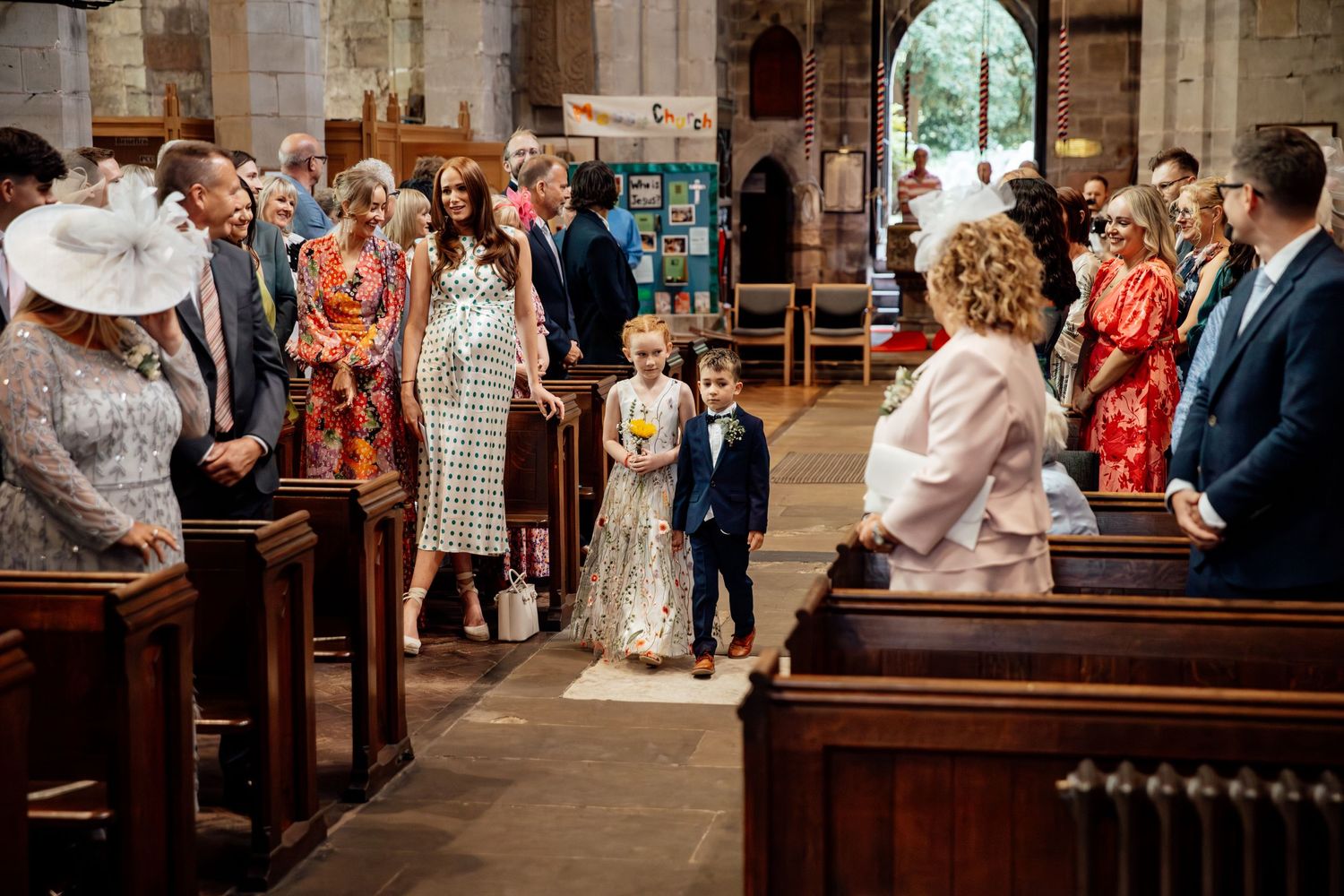 Wedding guests gather inside a historic stone church during a traditional ceremony.