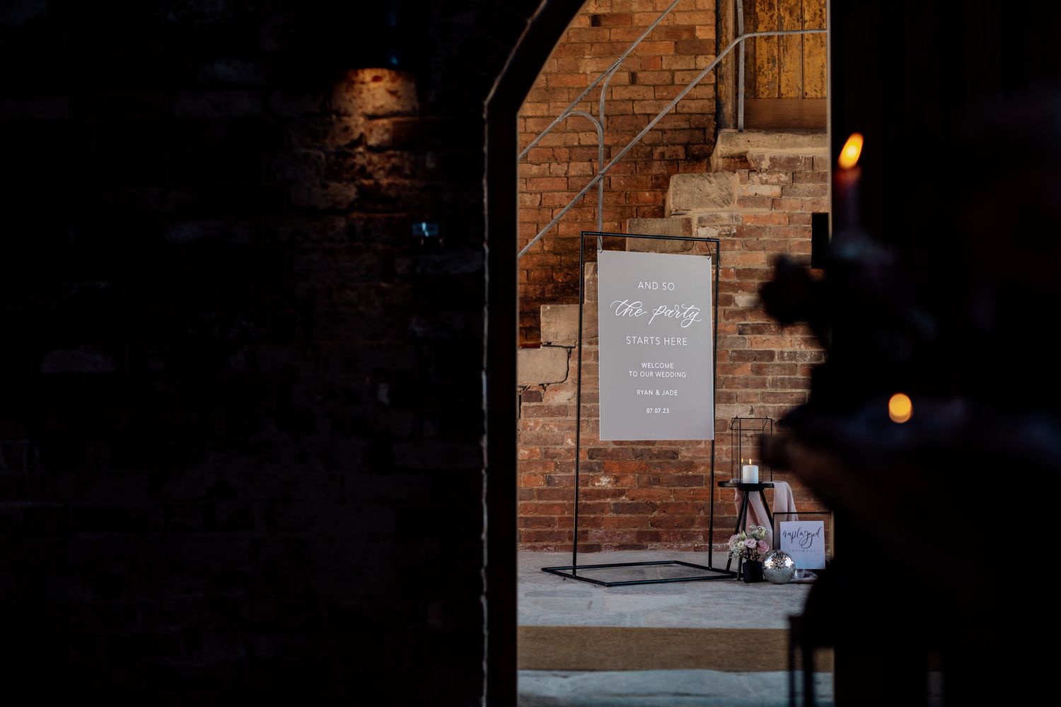 Dark and moody interior of a brick-walled venue space with ambient lighting.