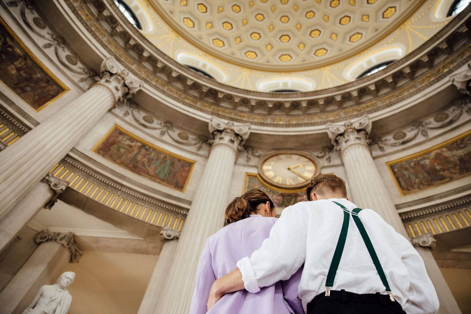 An ornate domed ceiling with classical architectural details and columns.