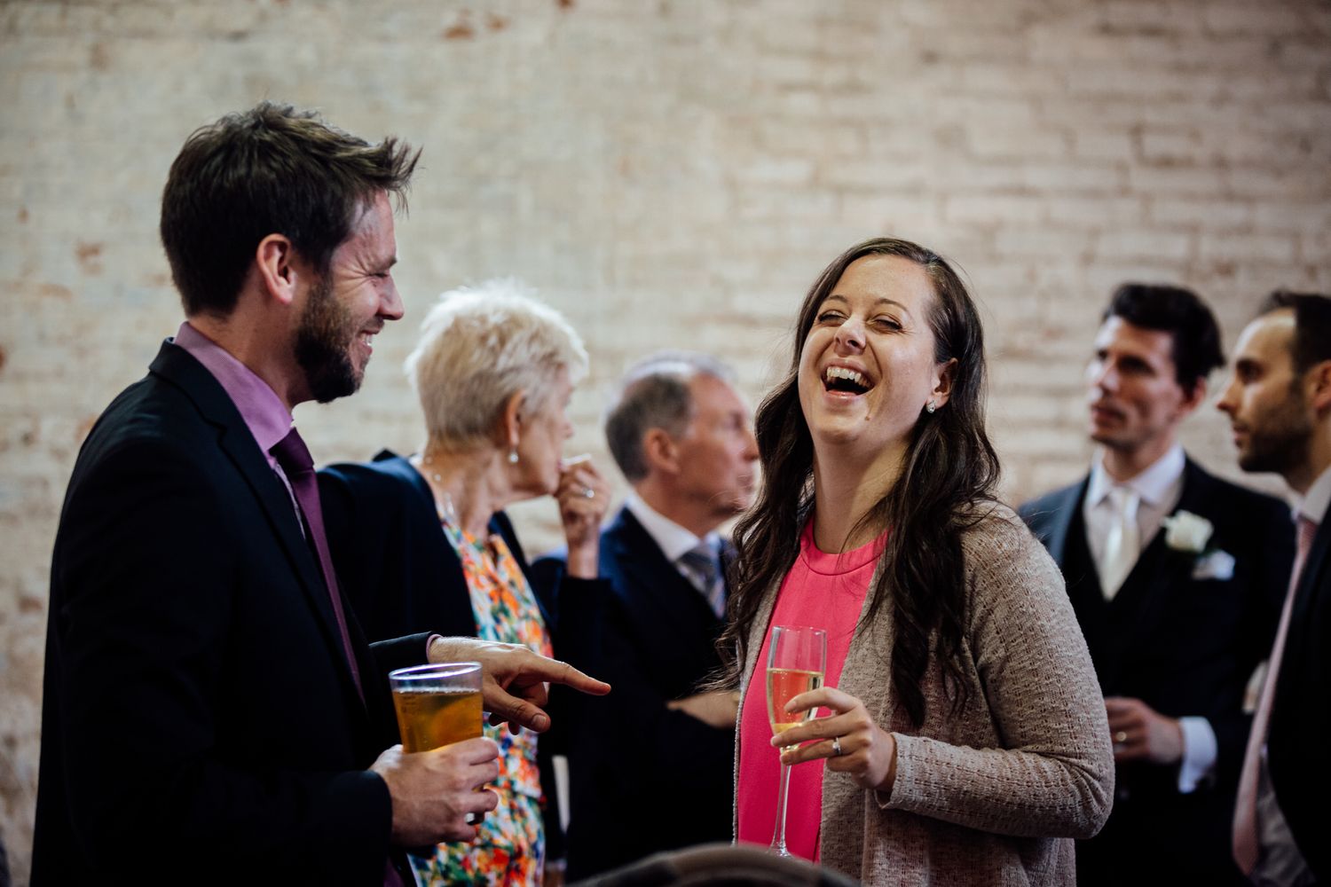 Candid moments of laughter shared between wedding guests.