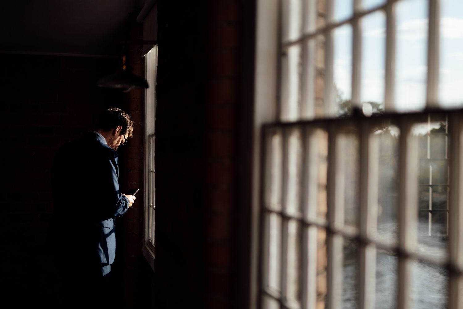 Sunlight streams through windows creating dramatic shadows in a historic building interior.