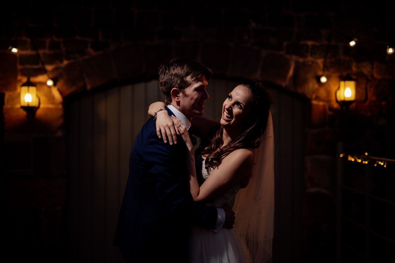 Romantic dance scene with warm amber lighting from hanging lanterns.