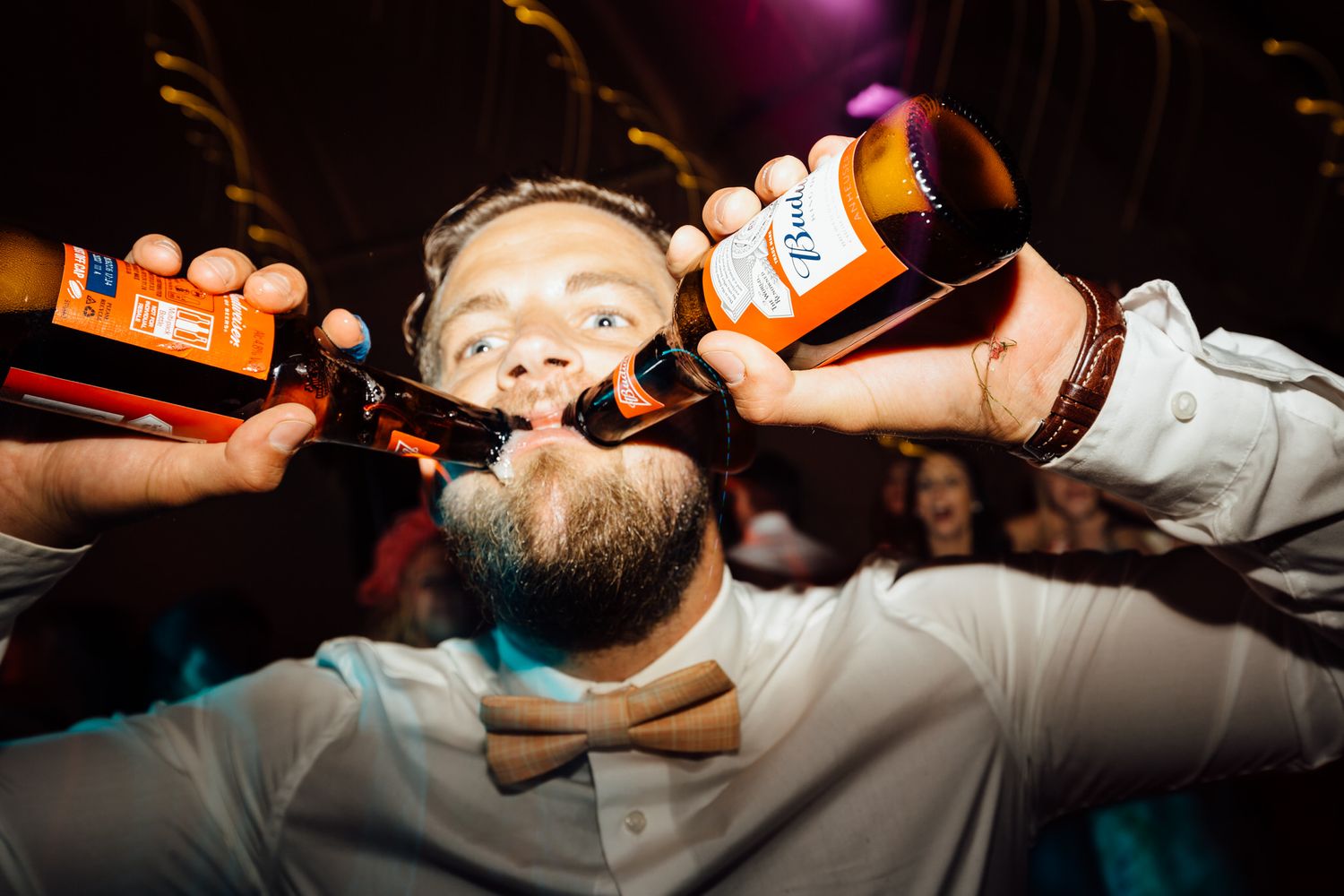 Party guests taking shots at a lively nighttime celebration.