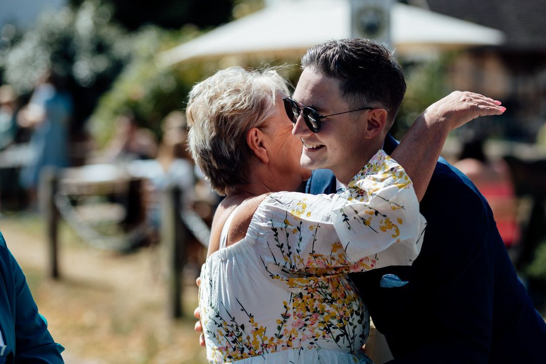 Candid outdoor wedding moments captured during a summer celebration.