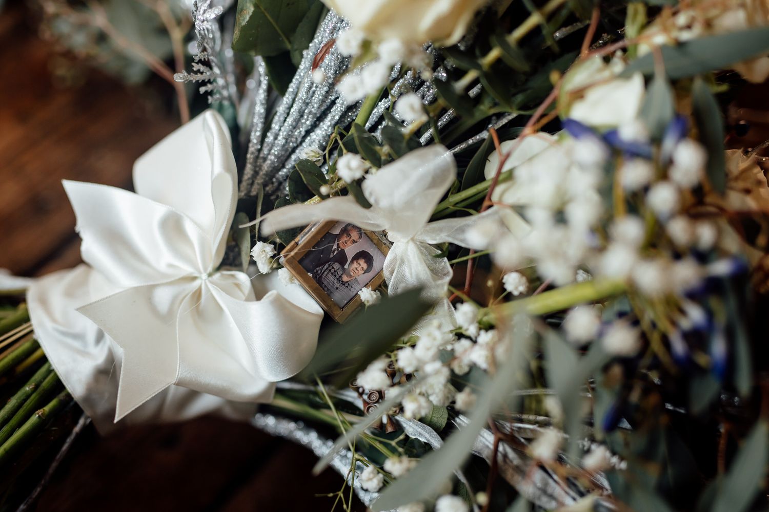 Delicate white floral wedding arrangements with greenery accents.