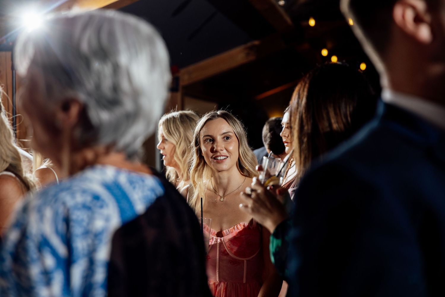 Wedding party dances and celebrates at an evening reception.