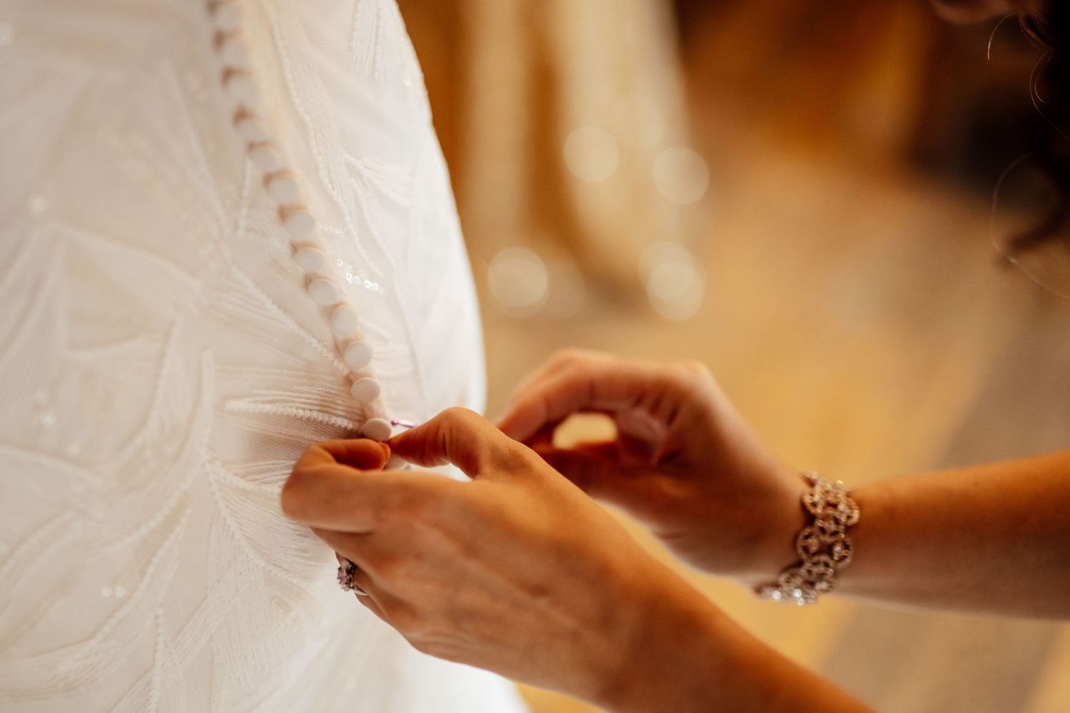 Close-up of hands during a wedding ceremony moment.