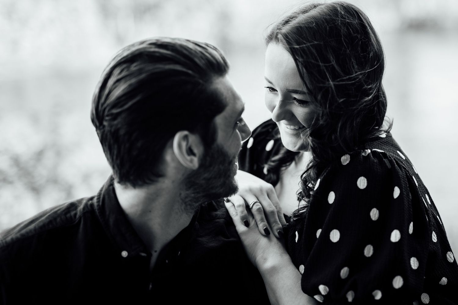 A romantic black and white portrait moment captured in a natural outdoor setting.