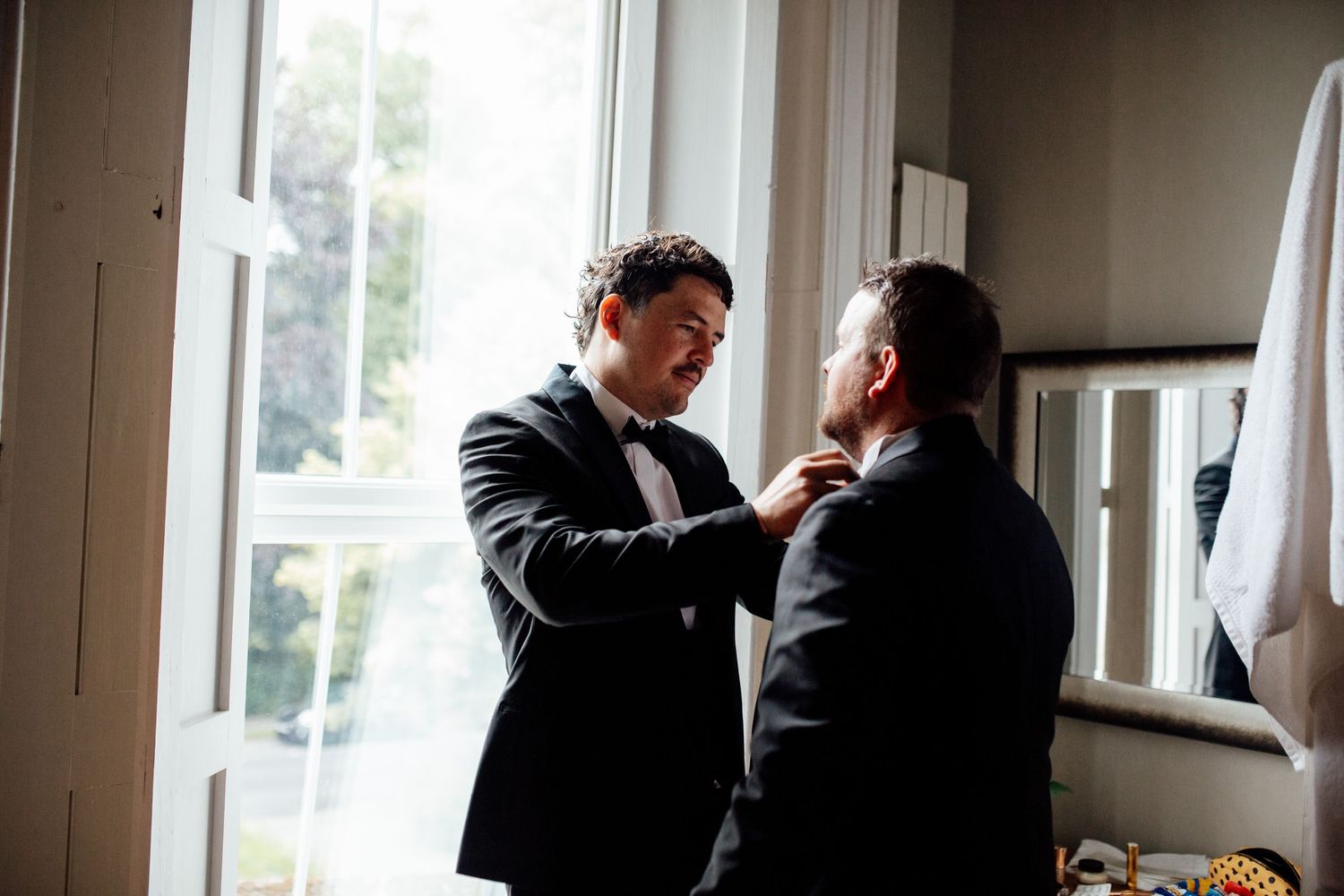 Guests mingling and chatting during an indoor wedding reception.
