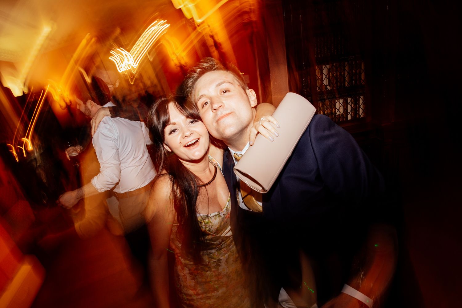 Dance party scene with warm orange lighting and celebratory atmosphere.