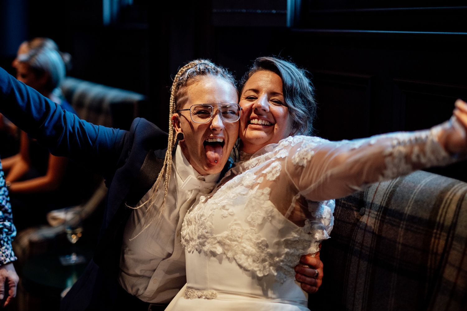 Two newlyweds celebrate with excitement on the dance floor.