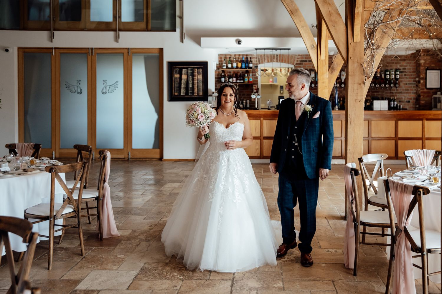 Spacious barn wedding venue with rustic wood details and natural light.