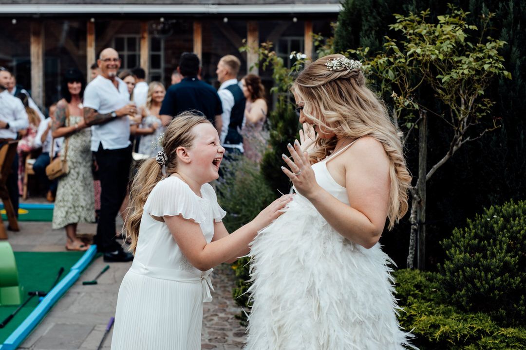 Joyful dancing and celebration scenes from wedding reception with brick wall backdrop.