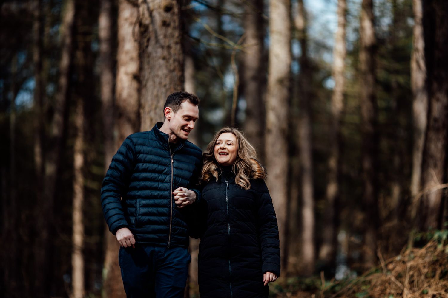Intimate outdoor photo session in a wooded area with natural lighting.