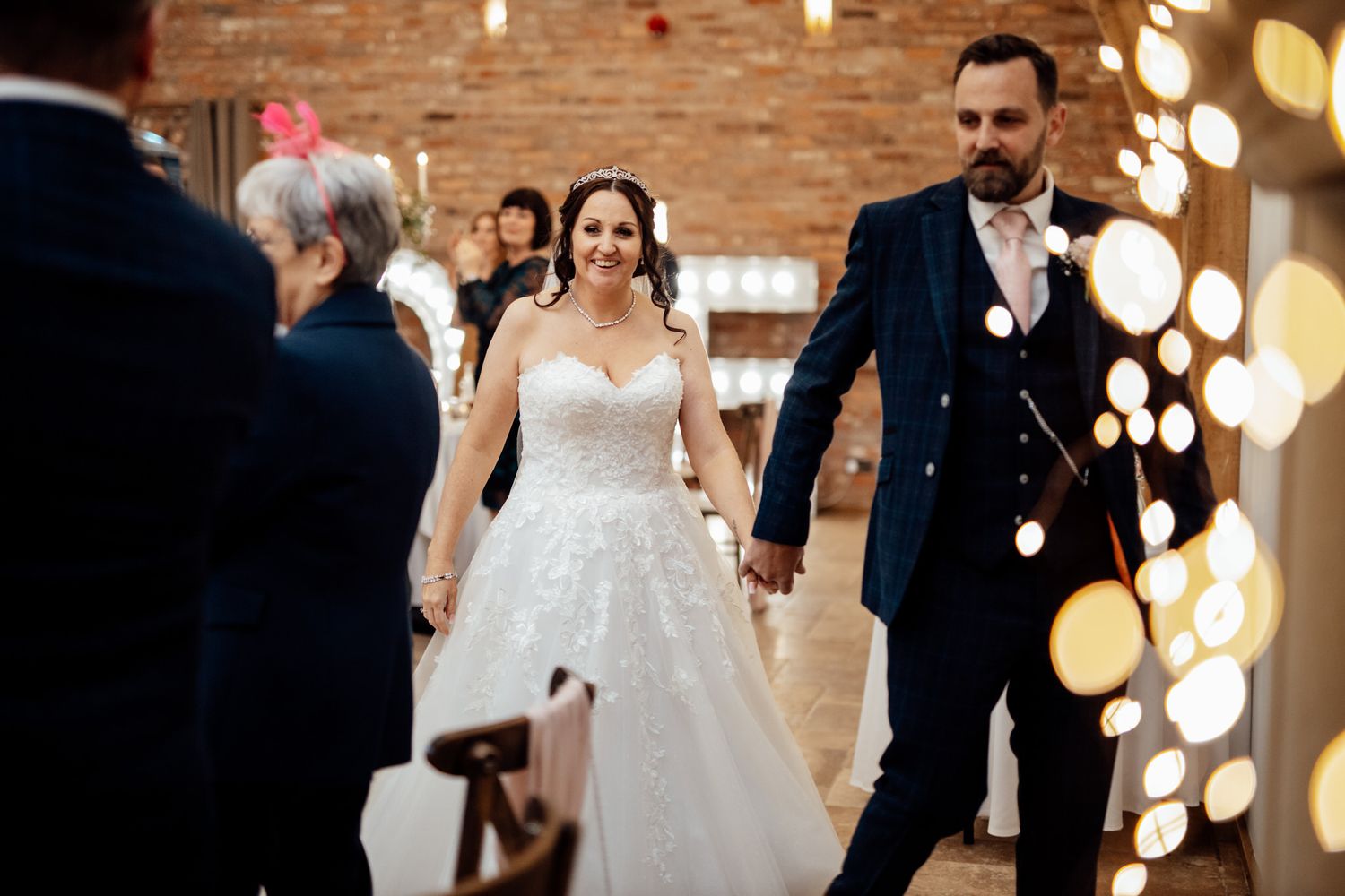 Wedding celebration in a rustic venue with warm lighting and exposed brick walls.