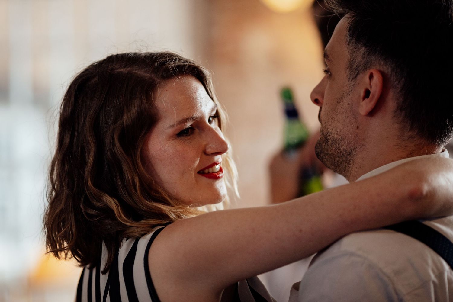Intimate moment between couple during evening wedding reception dance.