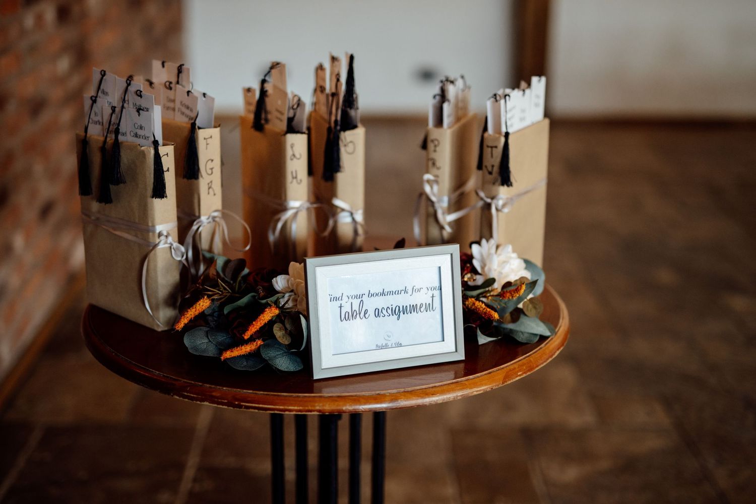 Decorative wedding details and signage displayed on a rustic wooden surface.