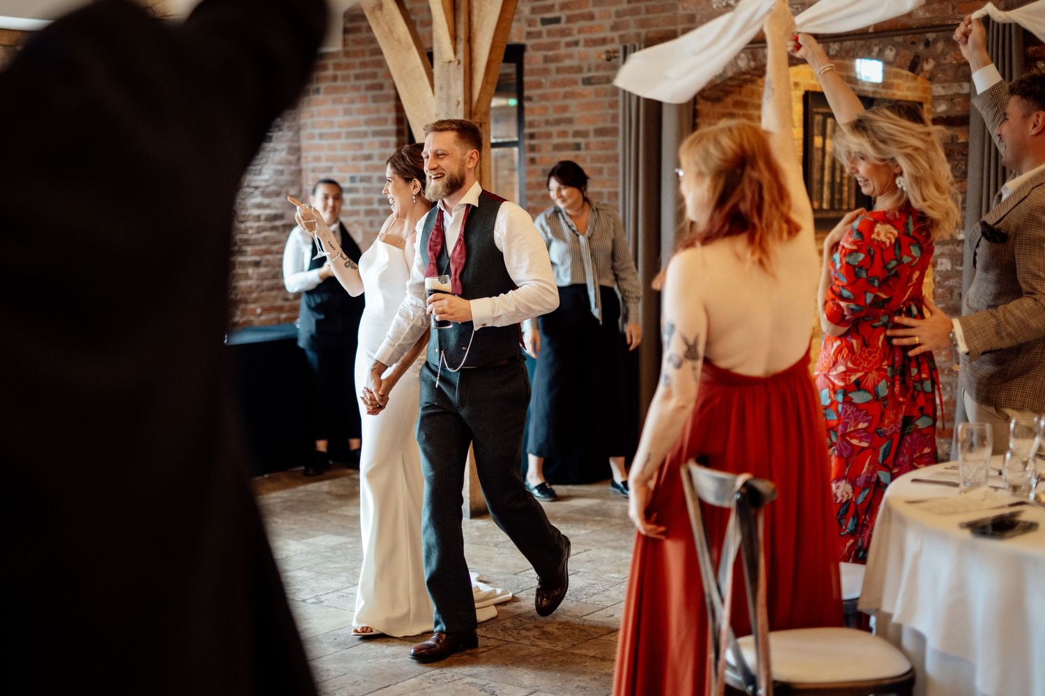 Wedding reception dance floor with guests in formal attire enjoying the celebration.