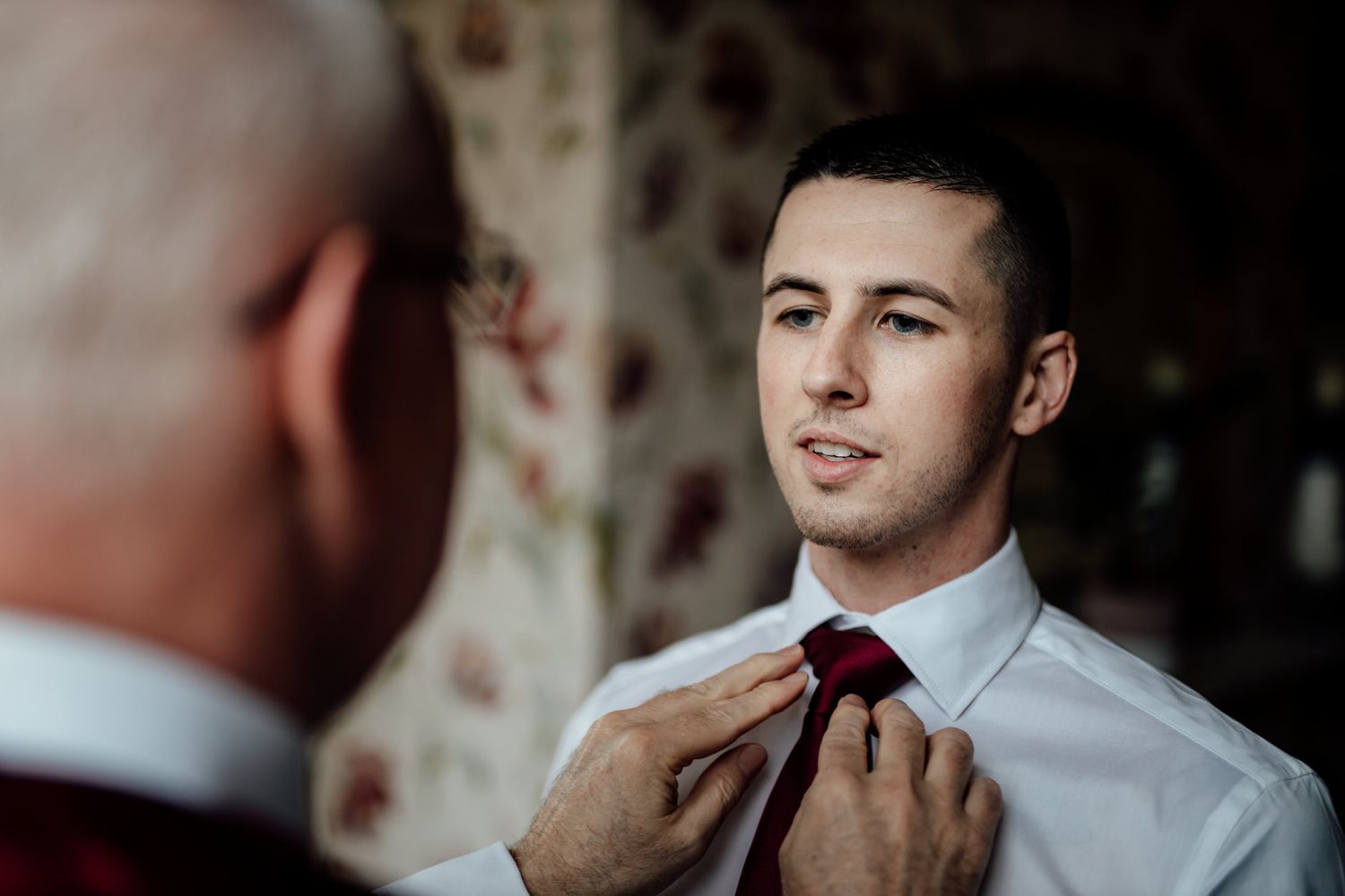 Wedding preparation moments captured in warm ambient lighting.