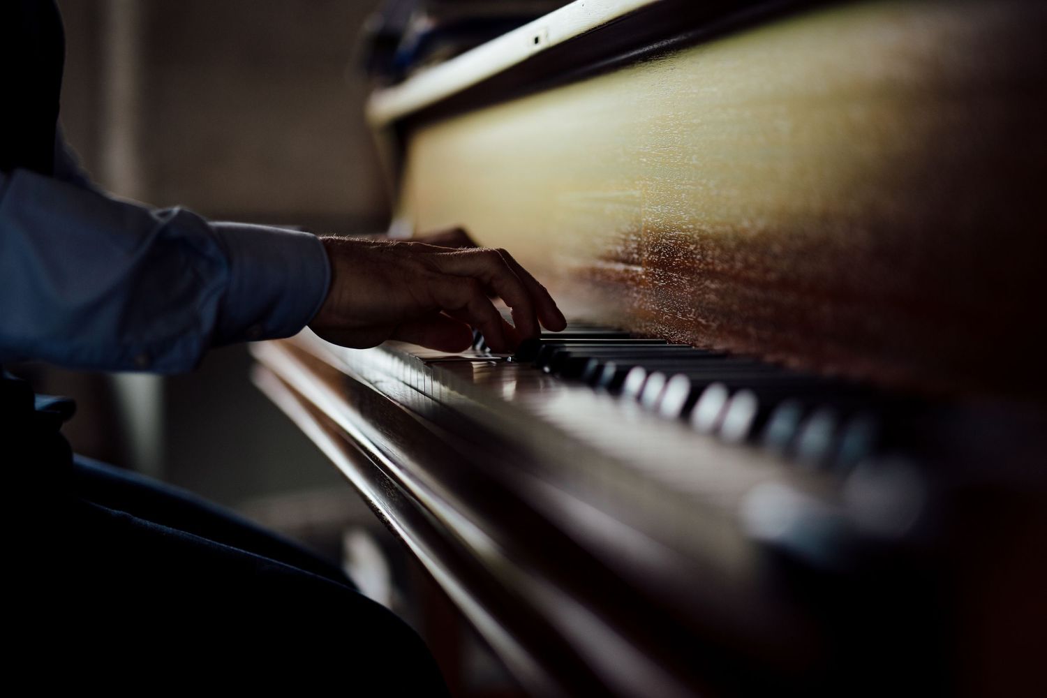 Artistic close-up of piano keys in dramatic lighting.