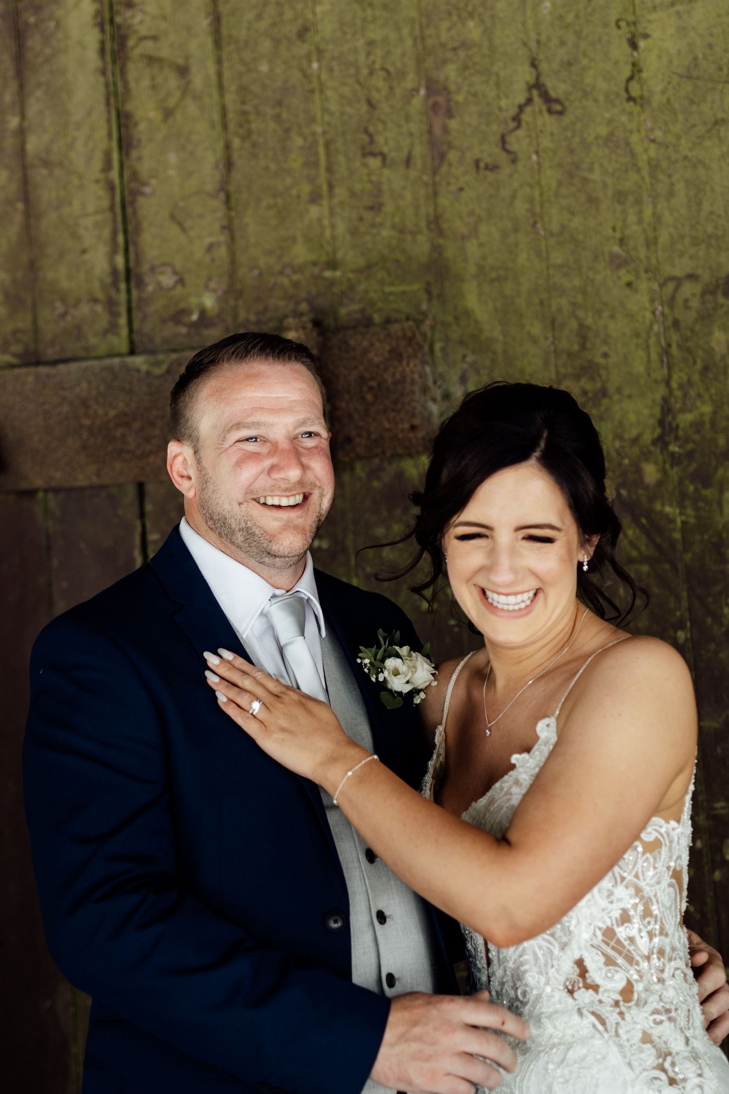 Joyful wedding couple sharing intimate laughs during their photo session.