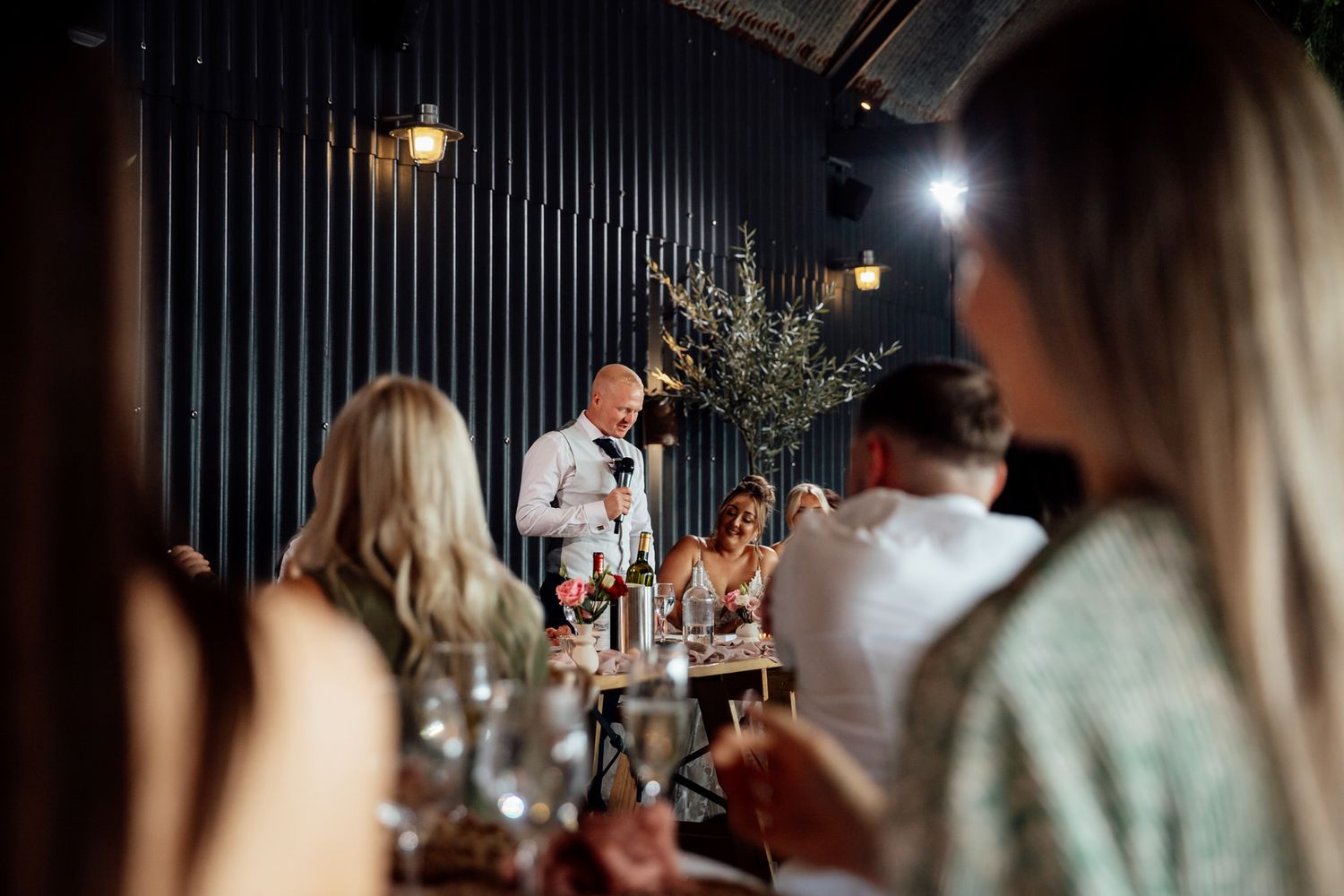 Dimly lit indoor reception venue with ambient lighting and decorative elements.