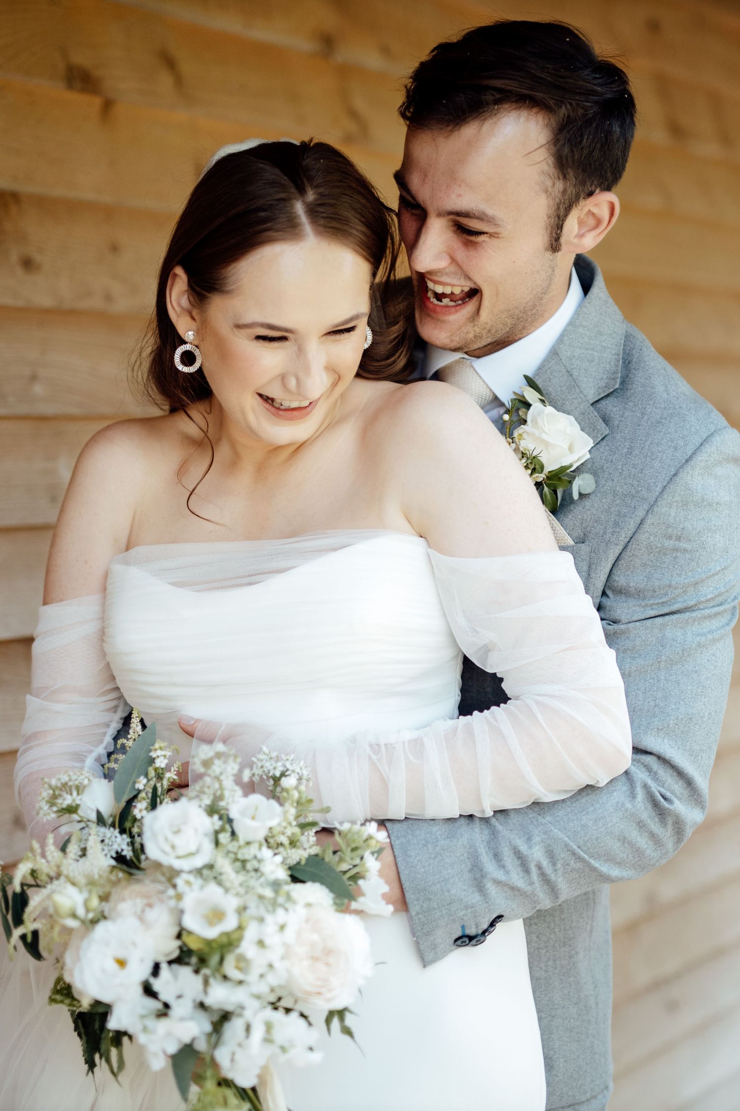 Romantic wedding portraits with bride in white dress holding floral bouquet.
