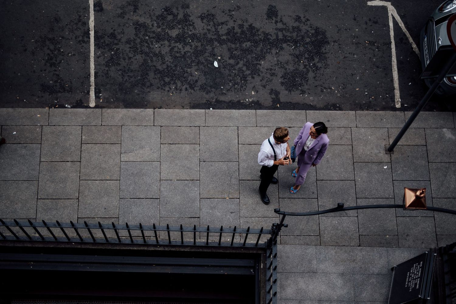 Aerial view of people walking on stone pavement from above.