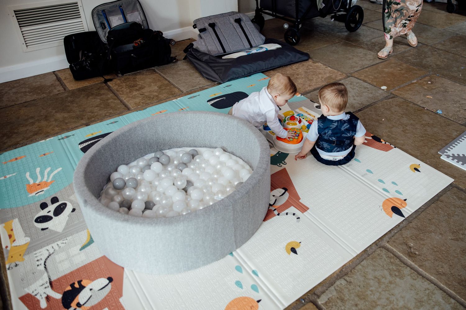 Children sitting at a table doing arts and crafts activities with cotton balls and paper.