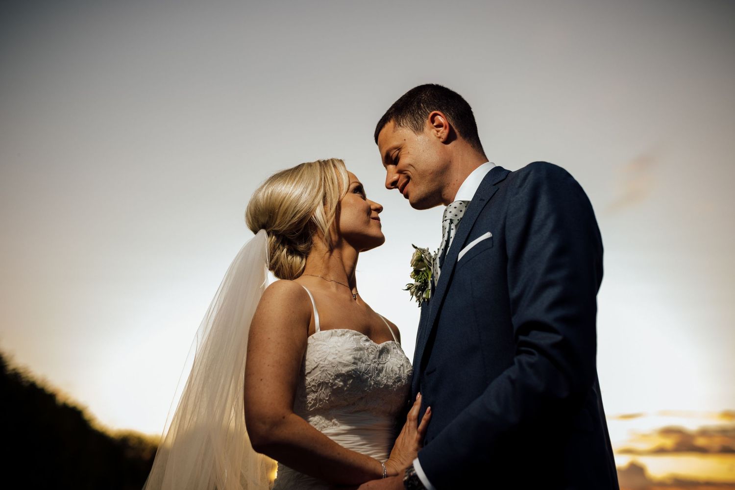 Romantic wedding portraits captured against a clean studio backdrop.