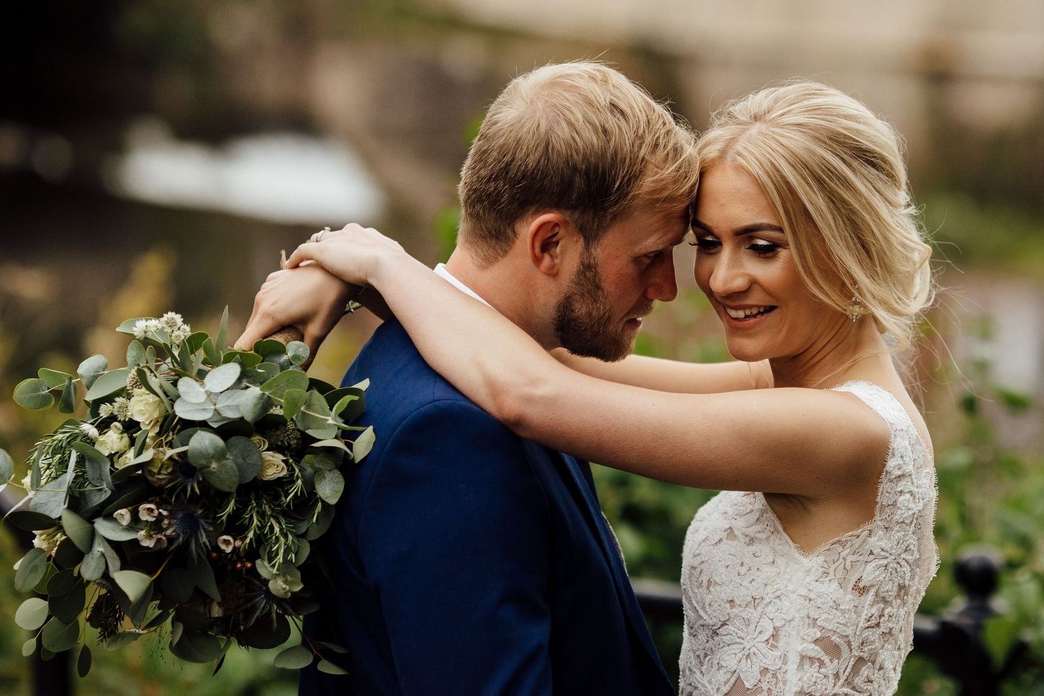 Intimate wedding couple portraits in garden setting with greenery.