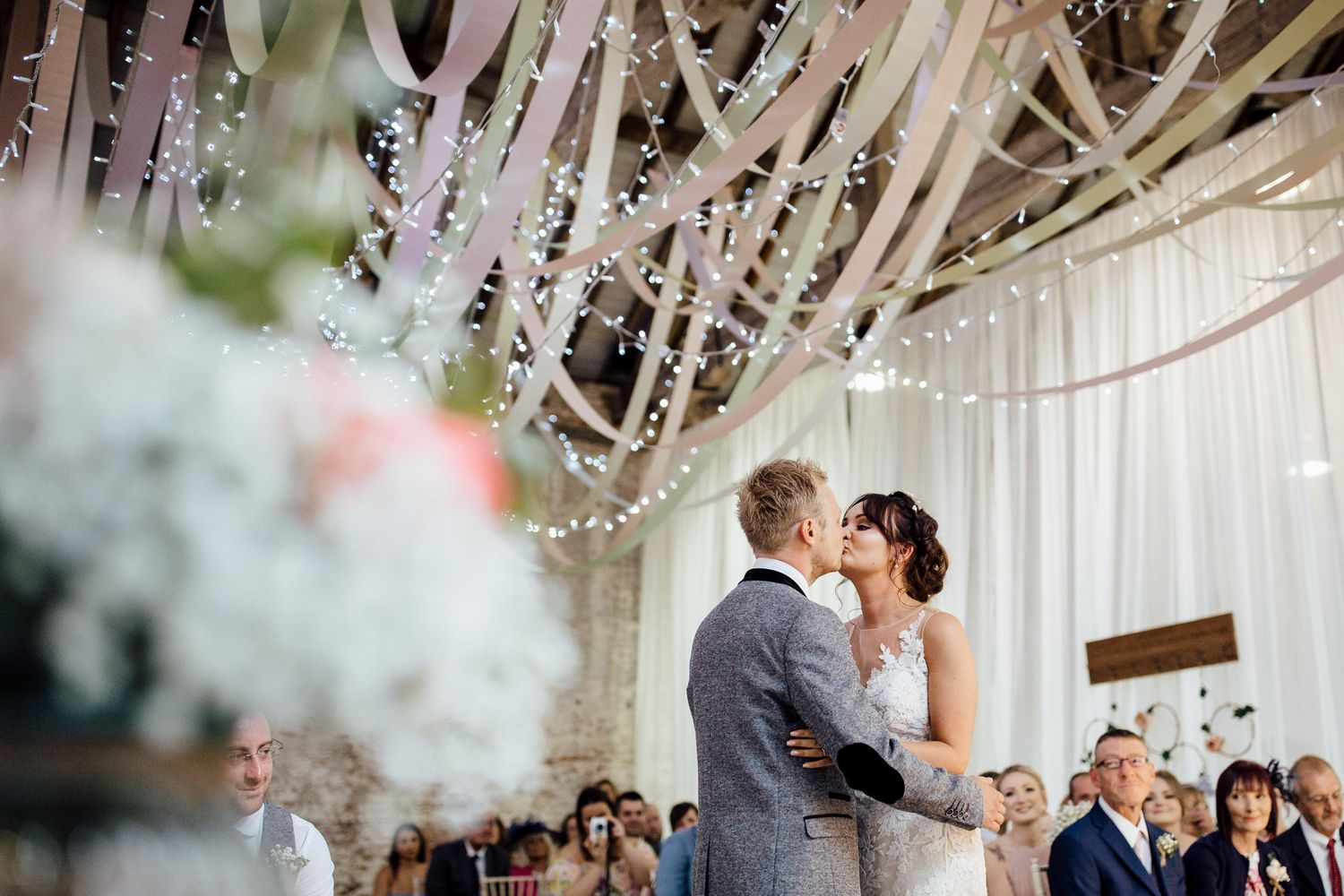 Wedding ceremony space with white draping and romantic lighting.