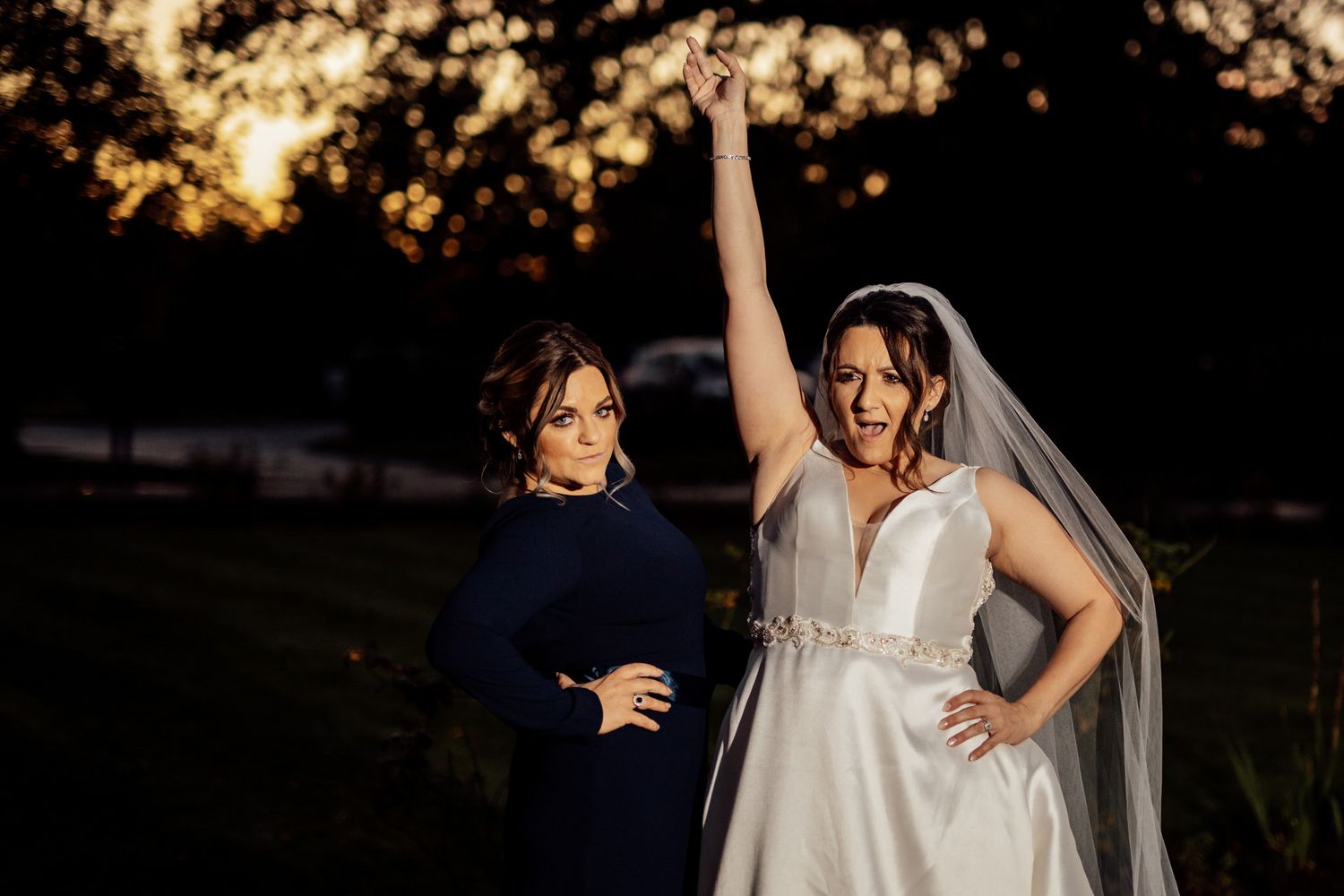 Golden hour wedding portraits with dreamy backlit atmosphere in garden setting.