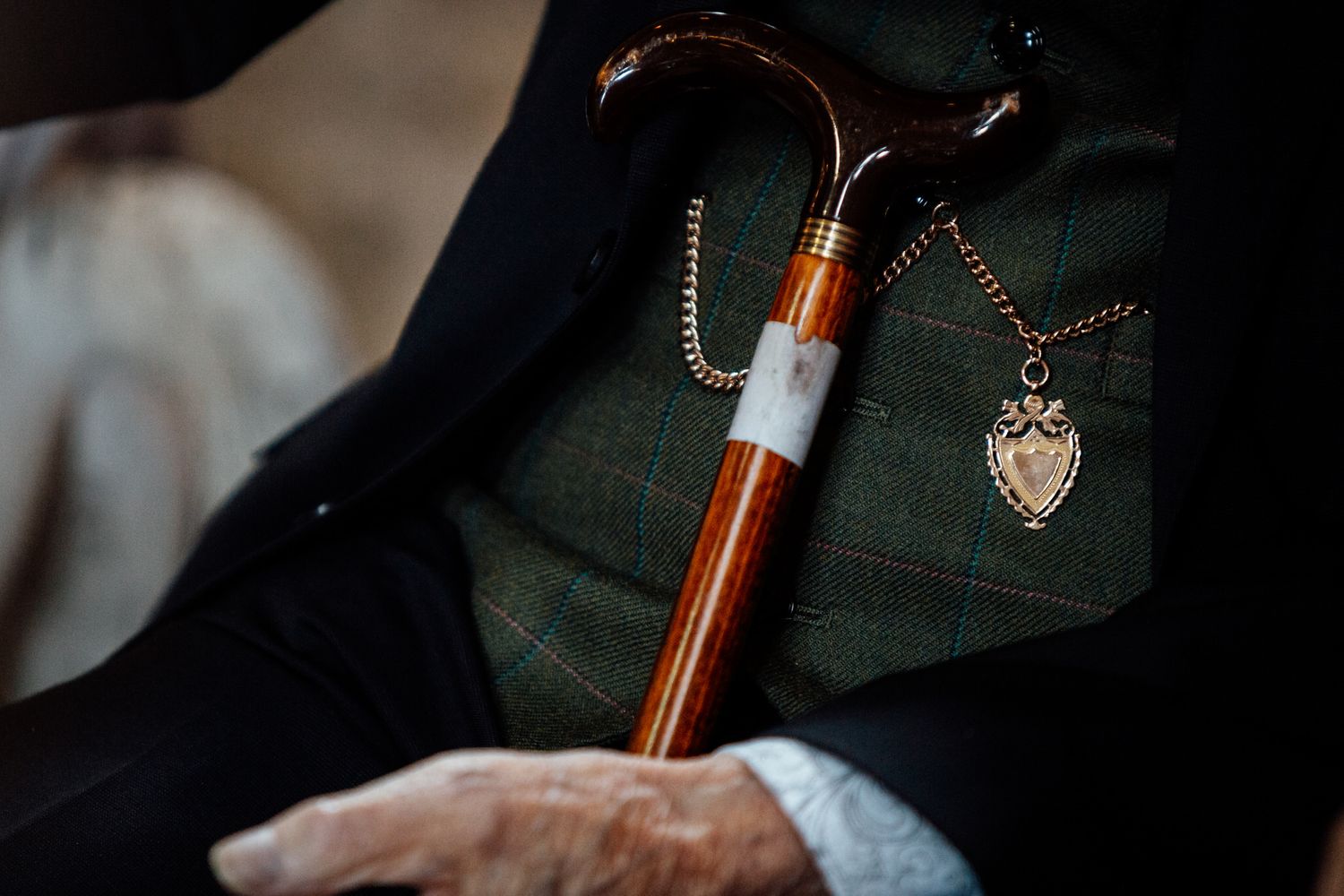 Detail shot of formal attire with plaid pattern and accessories.